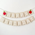 Handcrafted Apple Happy Birthday banner hanging for first birthday party