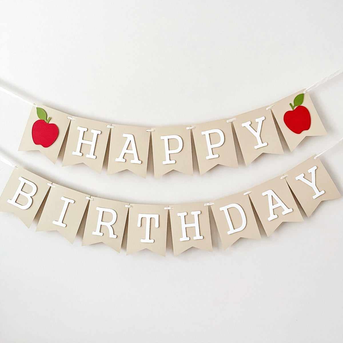 Handcrafted Apple Happy Birthday banner hanging for first birthday party