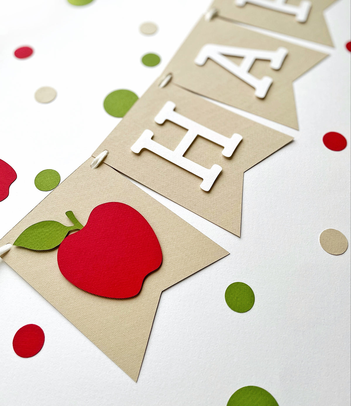 Detailed red apple cardstock pennant on kraft birthday banner