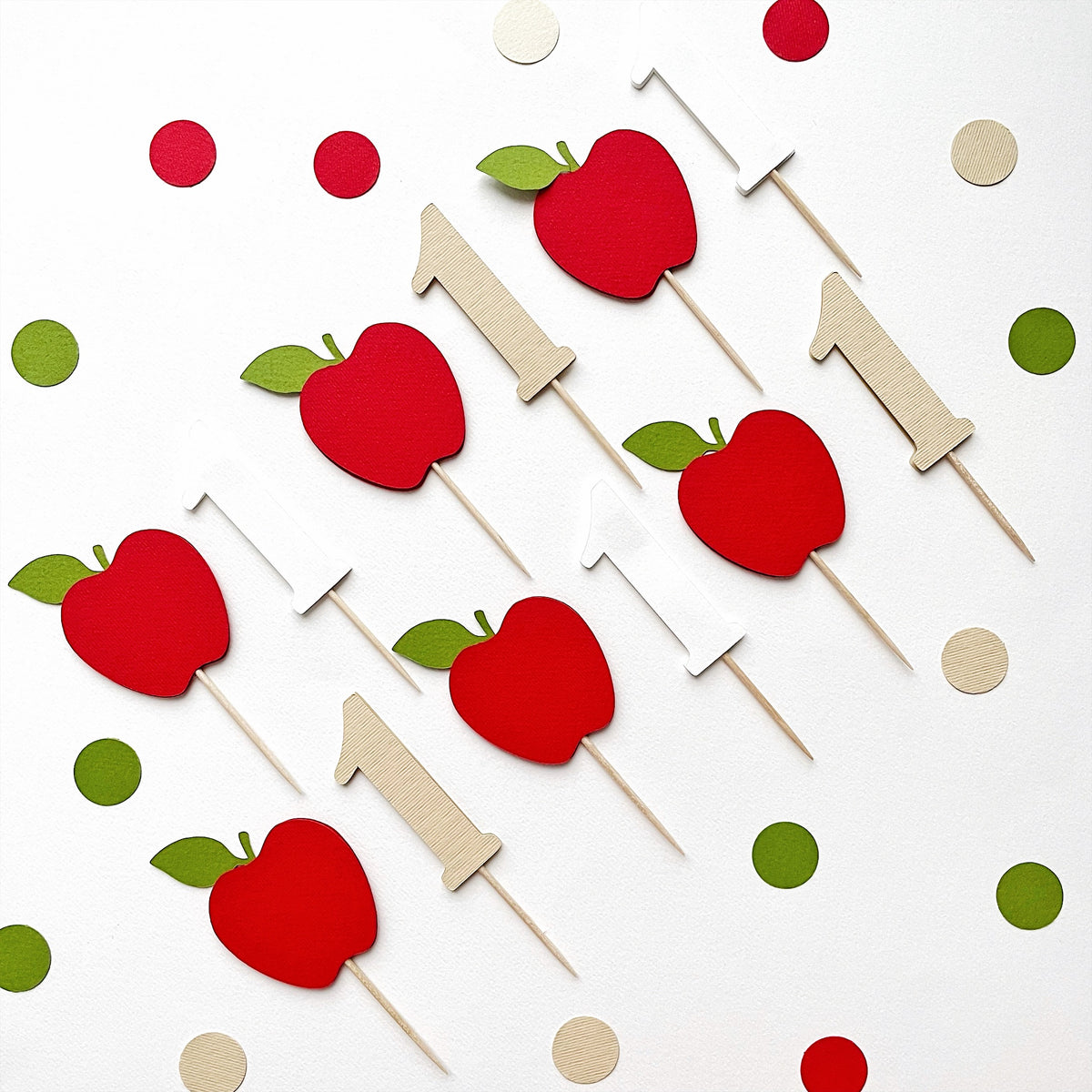 1st birthday apple and number 1 cupcake toppers spread on confetti background