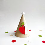 Handcrafted kraft cone party hat with red cardstock apple for cake smash session