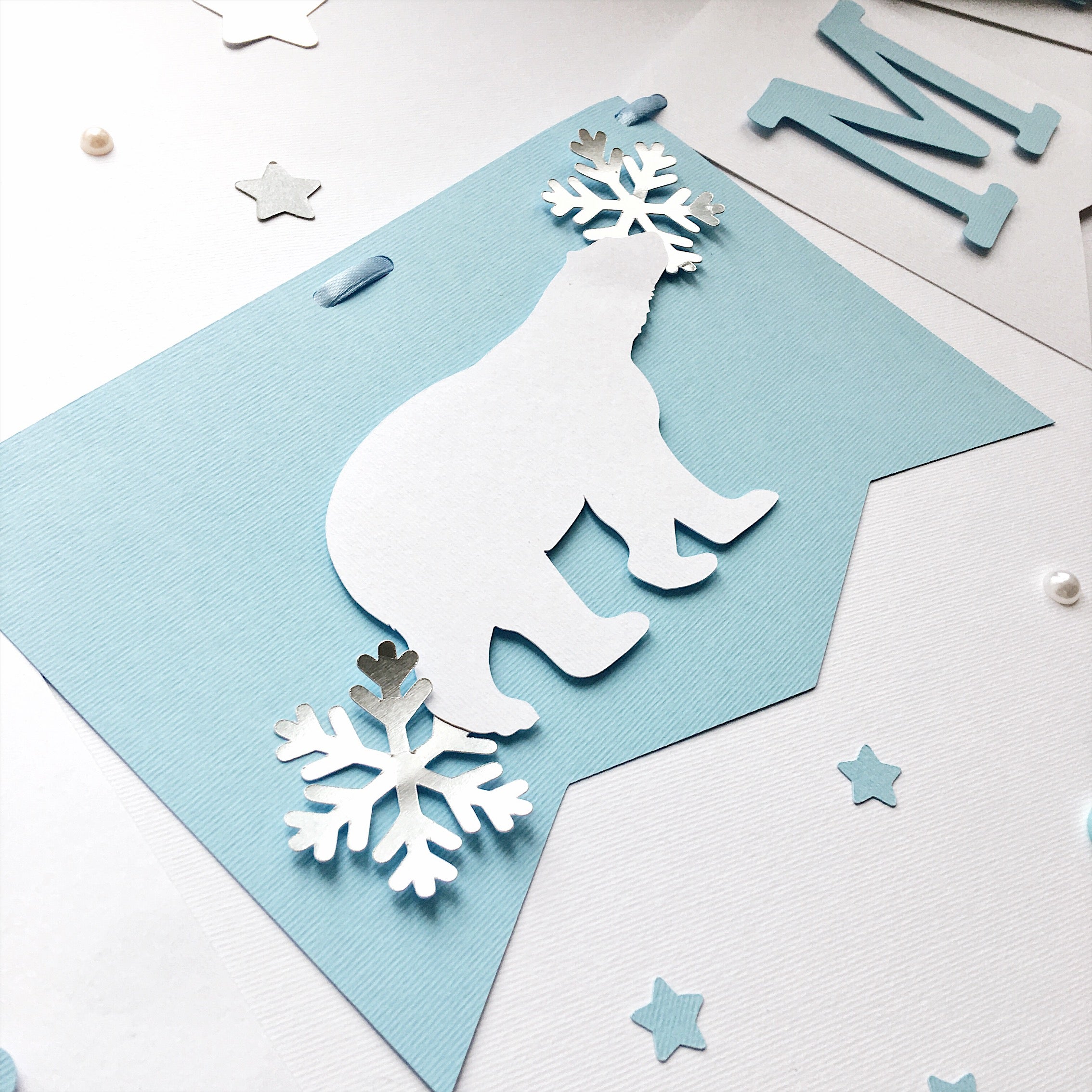 Polar Bear Baby Shower Name Banner in white and dusty blue for a winter gender reveal party.
