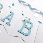 Polar Bear Baby Shower Name Banner in white and dusty blue for a winter gender reveal party.
