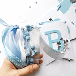 Polar Bear Baby Shower Name Banner in white and dusty blue for a winter gender reveal party.