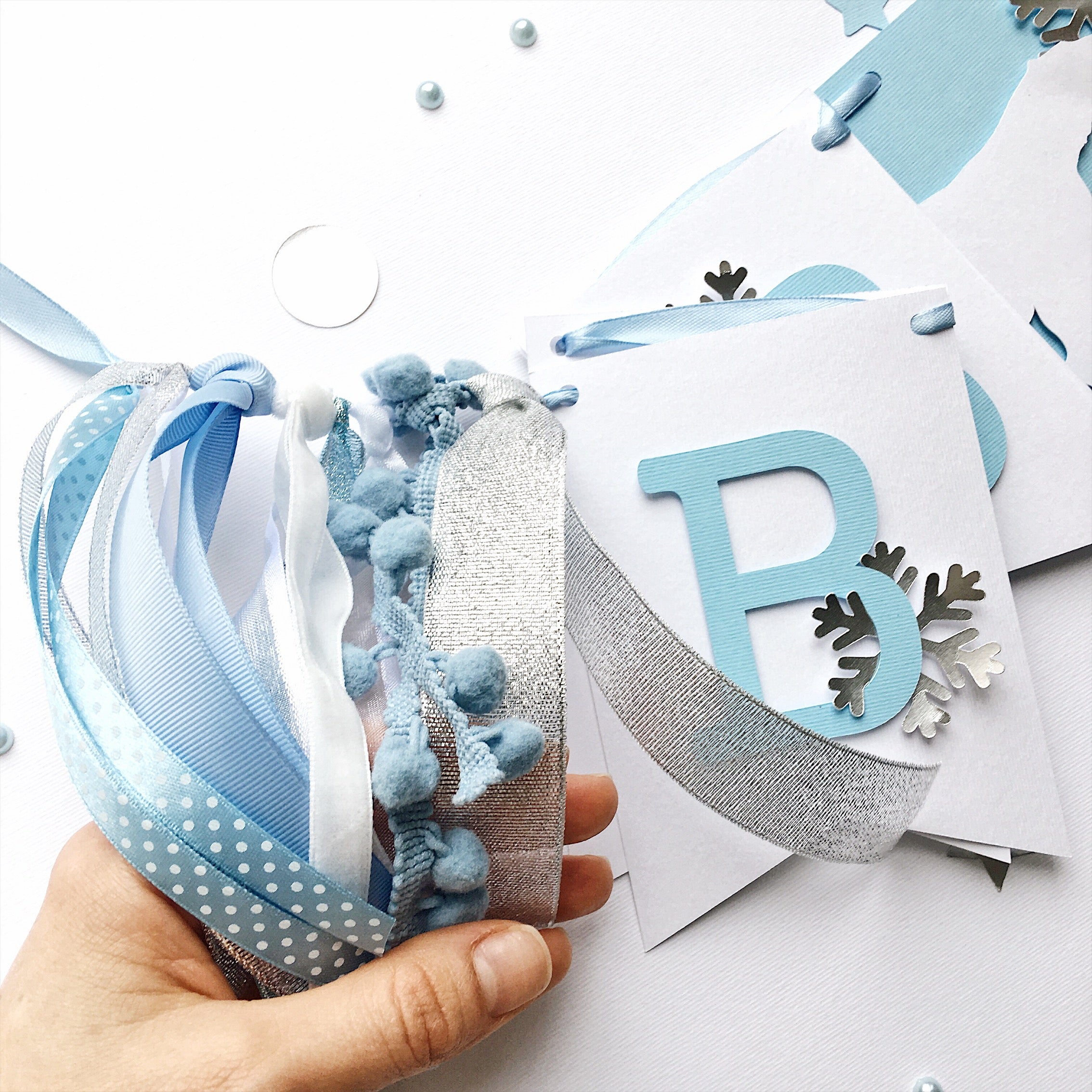 Polar Bear Baby Shower Name Banner in white and dusty blue for a winter gender reveal party.