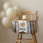 Teddy bear themed 1st birthday highchair garland on a wooden high chair for a beary first birthday cake smash photoshoot.