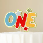 Colorful 'ONE' cake topper with stars on a neutral background