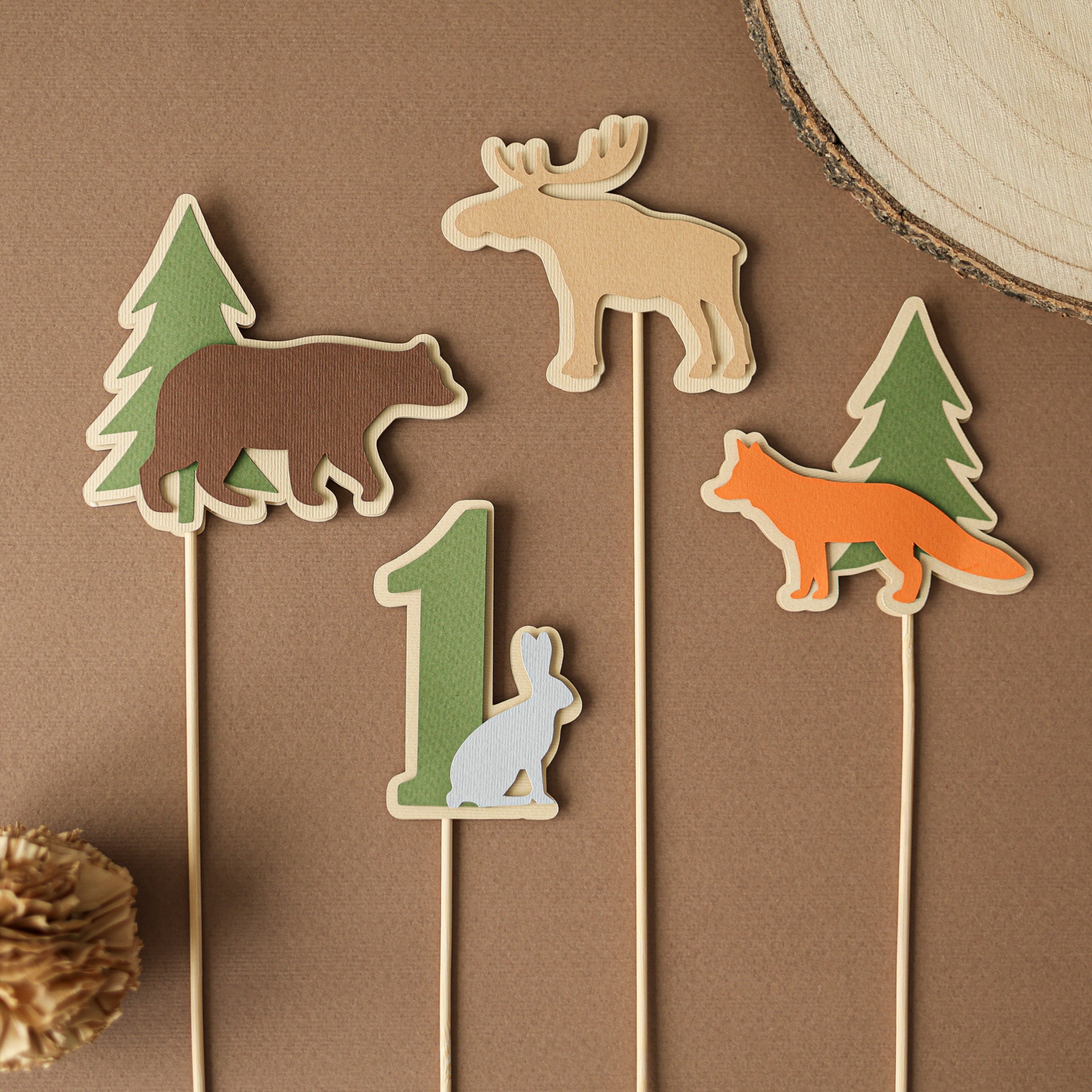 Woodland First Birthday centerpiece with green number one and forest animals including fox and bear for Respect The Locals party theme.