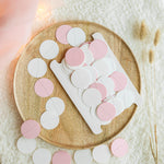 Handmade pink white and grey paper circle garland wrapped on storage card
