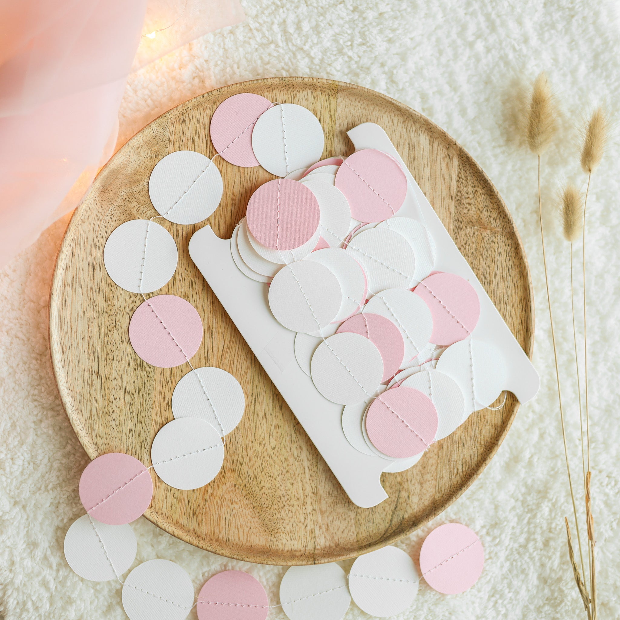 Handmade pink white and grey paper circle garland wrapped on storage card