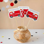 Decorative centerpieces with fire truck design and number.