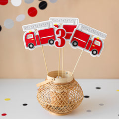 Decorative centerpieces with fire truck design and number.