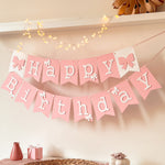 Handcrafted pink paper banner flag with bow accents and fairy lights