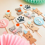 A set of cute animal party toppers for a  birthday, including cat and dog figures, paw print signs, and number circles