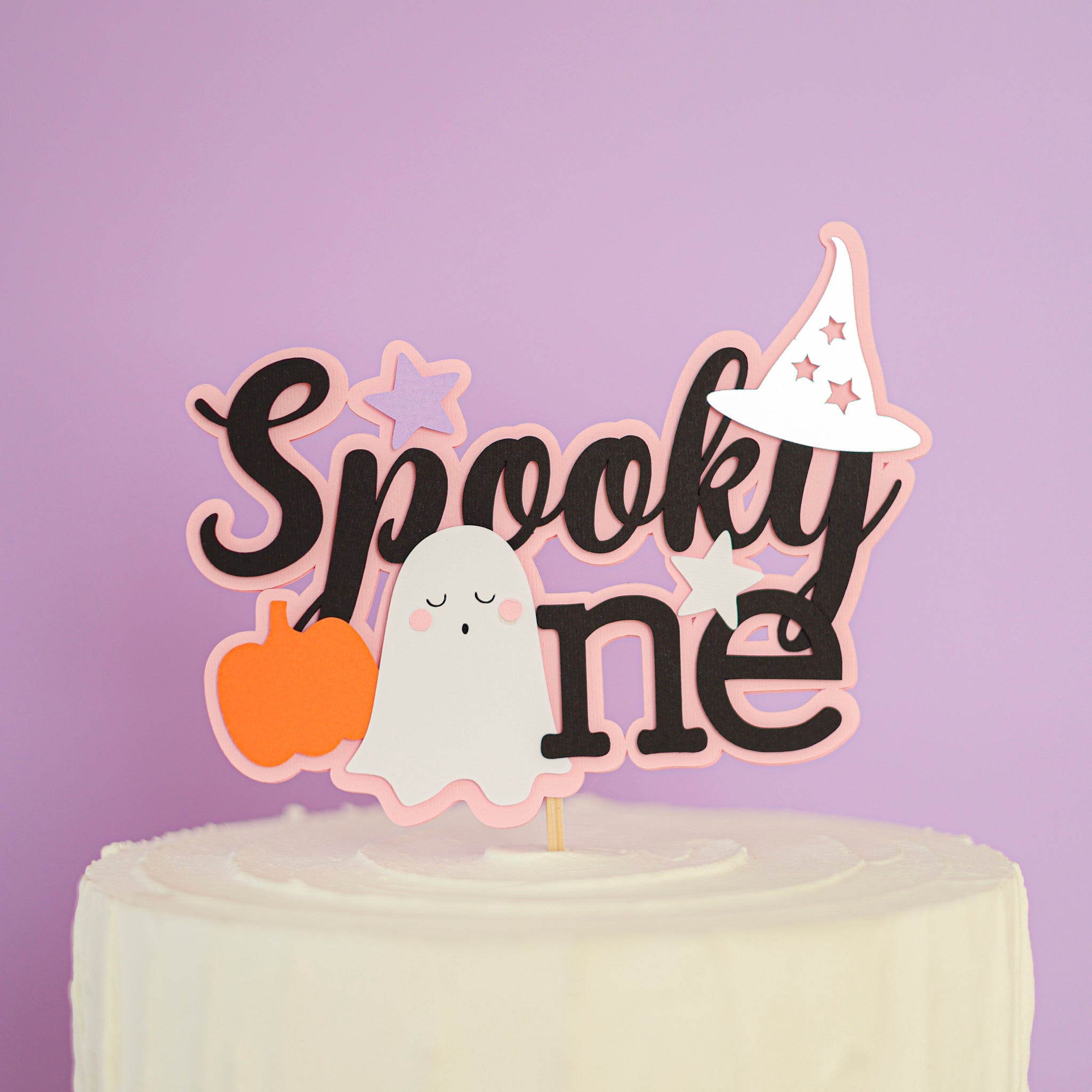 Halloween themed cake topper with 'Spooky One' text, ghost, and pumpkin for celebrating 1st Birthday 