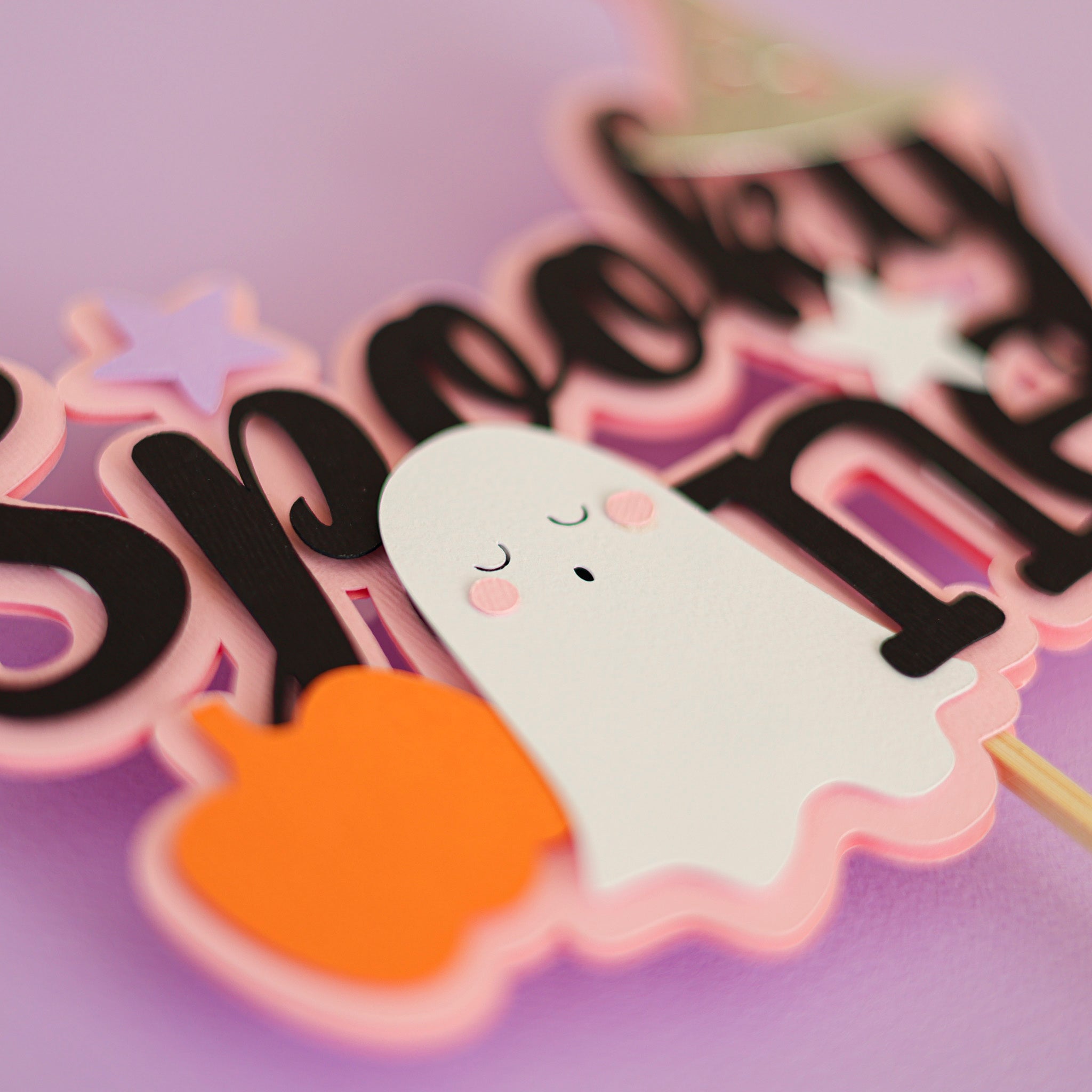 Halloween themed cake topper with 'Spooky One' text, ghost, and pumpkin for celebrating 1st Birthday 