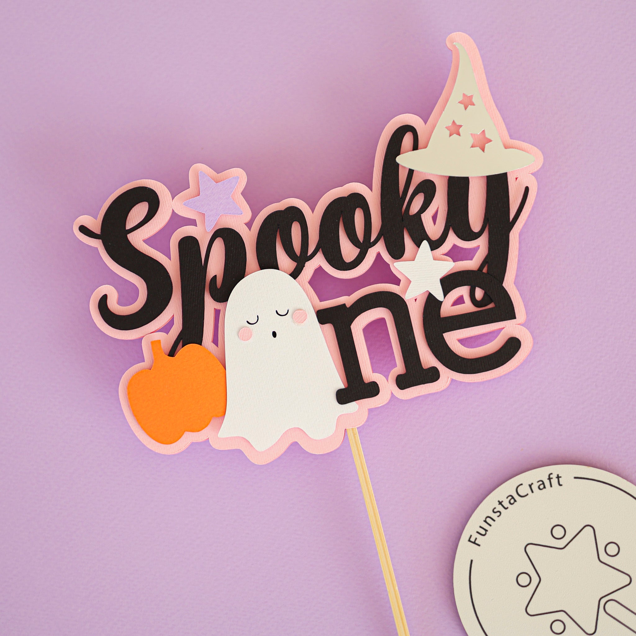 Halloween themed cake topper with 'Spooky One' text, ghost, and pumpkin for celebrating 1st Birthday 