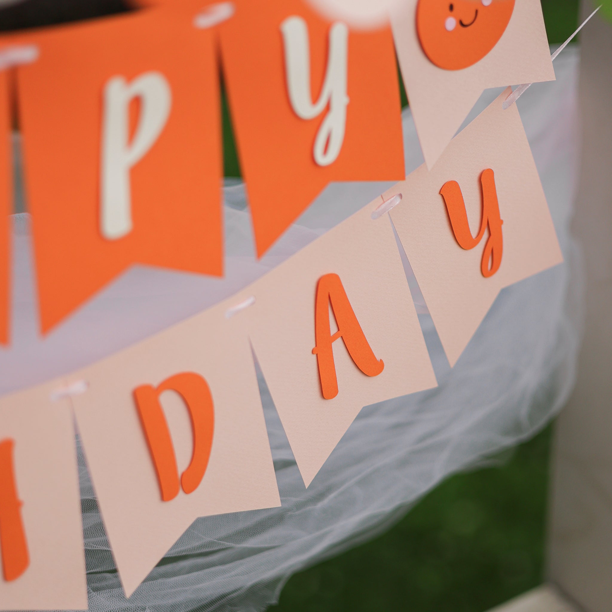 Close-up of a 'Little Cutie' themed first birthday banner. First birthday Little Cutie banner, orange citrus party decor, baby 1st birthday sign