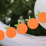 Little Cutie themed orange fruit garland for a birthday or baby shower, hanging outdoors