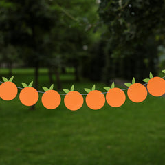 Little Cutie themed orange fruit garland for a birthday or baby shower, hanging outdoors