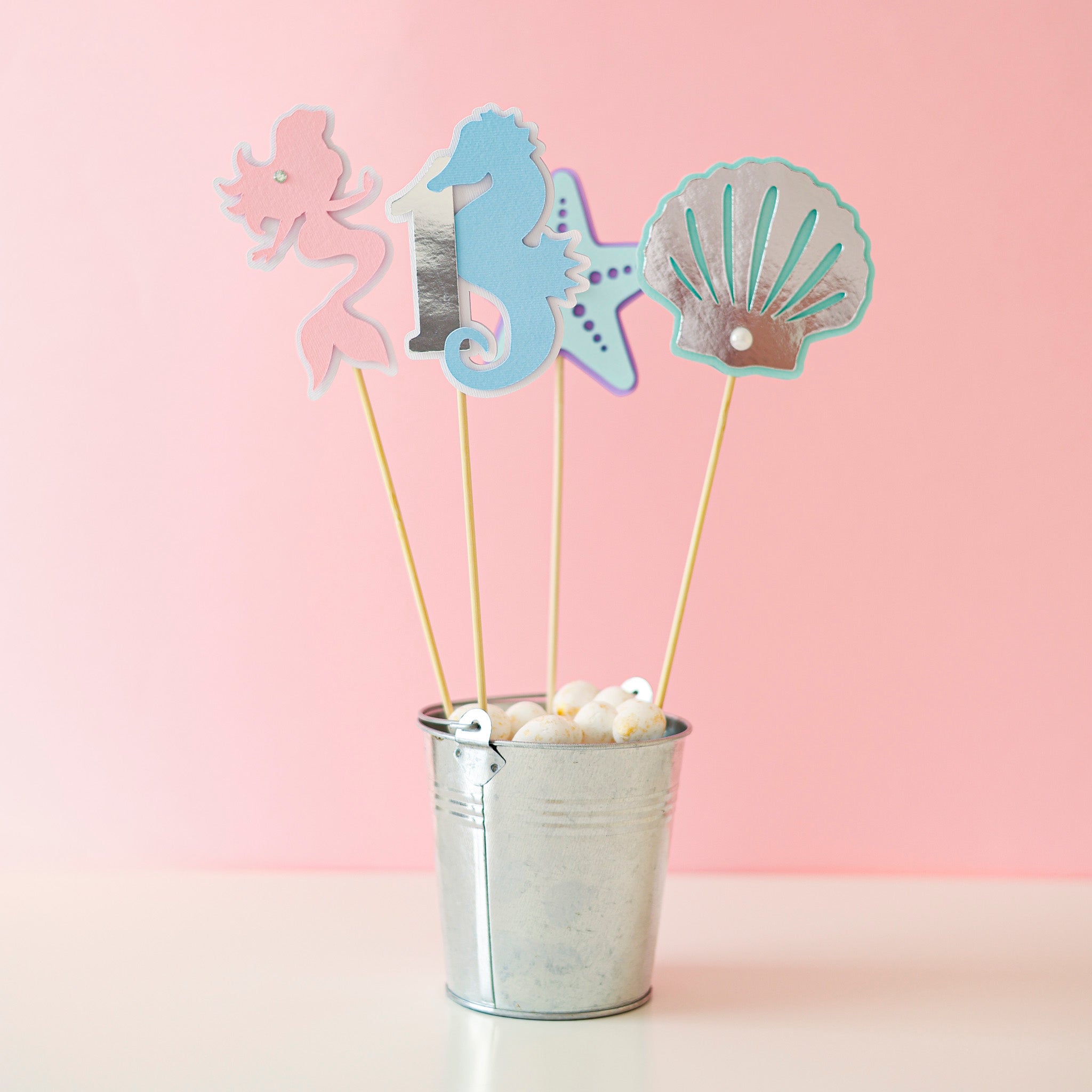 Handmade pastel mermaid 1st birthday centerpiece sticks set with pink mermaid, seahorse number 1, starfish, and silver seashell table decor