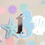 Pastel blue seahorse wrapped around a silver foil number 1 centerpiece stick for under the sea 1st birthday party