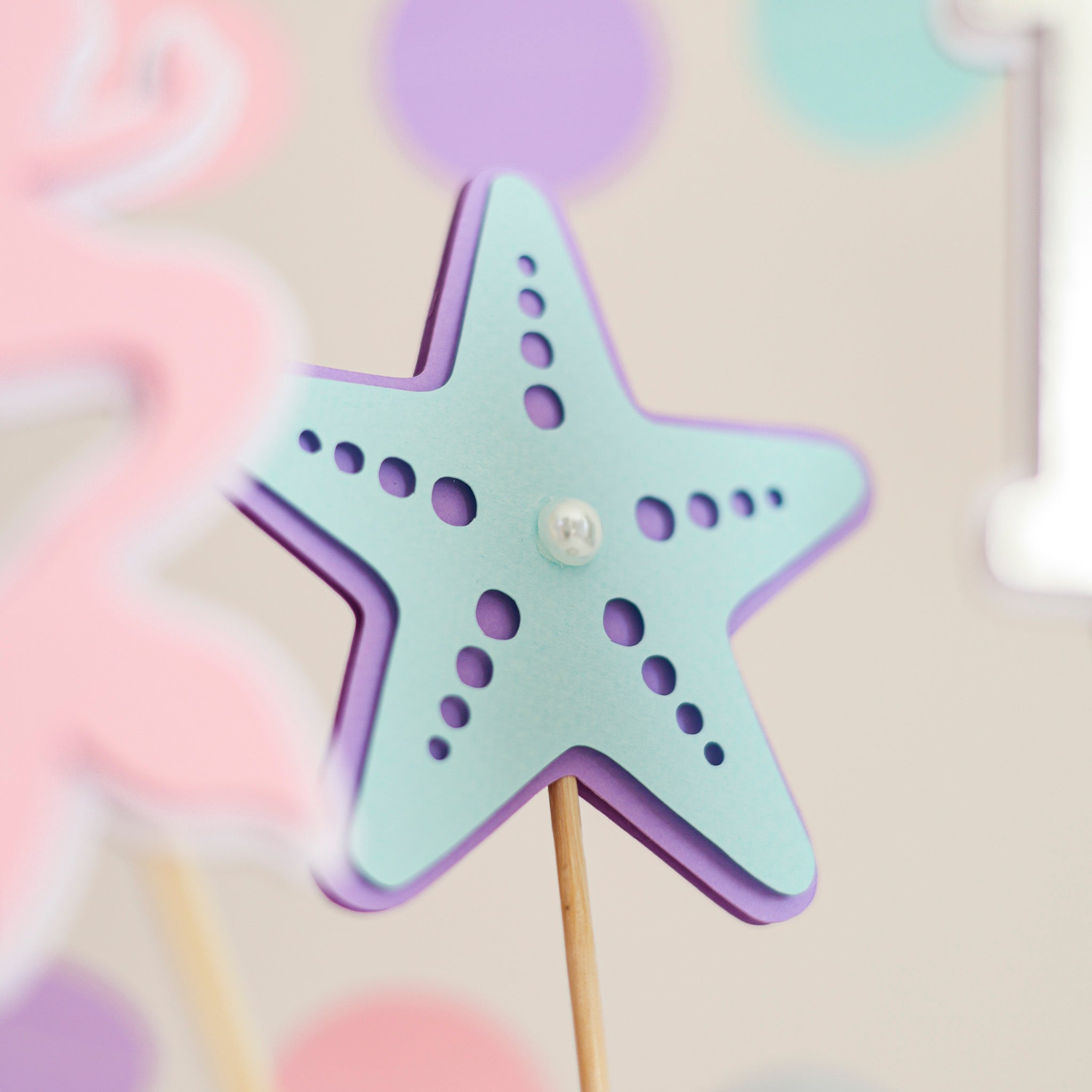 Shimmering silver paper seashell and light blue starfish with pearl centerpiece sticks for baby girl birthday