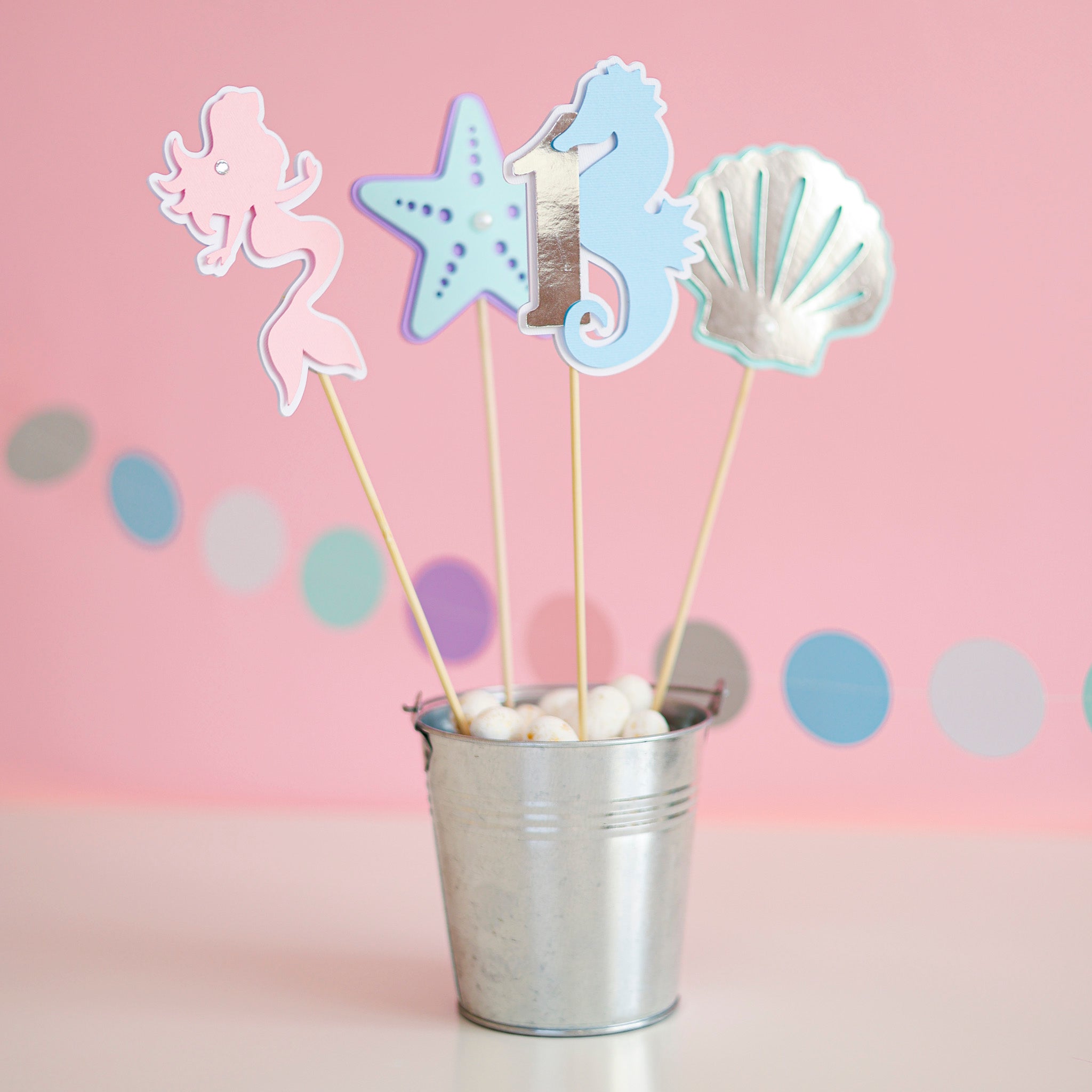 Handmade pastel mermaid 1st birthday centerpiece sticks set with pink mermaid, seahorse number 1, starfish, and silver seashell table decor