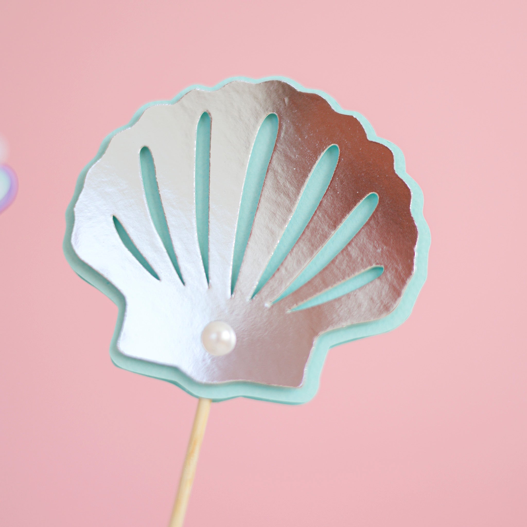 Shimmering silver paper seashell and light blue starfish with pearl centerpiece sticks for baby girl birthday