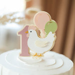 Cake topper with a chicken and number '1' 