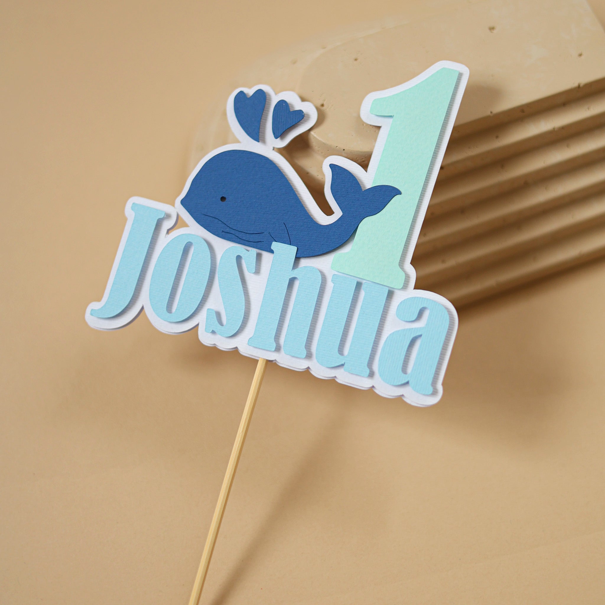 Personalized cake topper with whale design and name 'Joshua' 