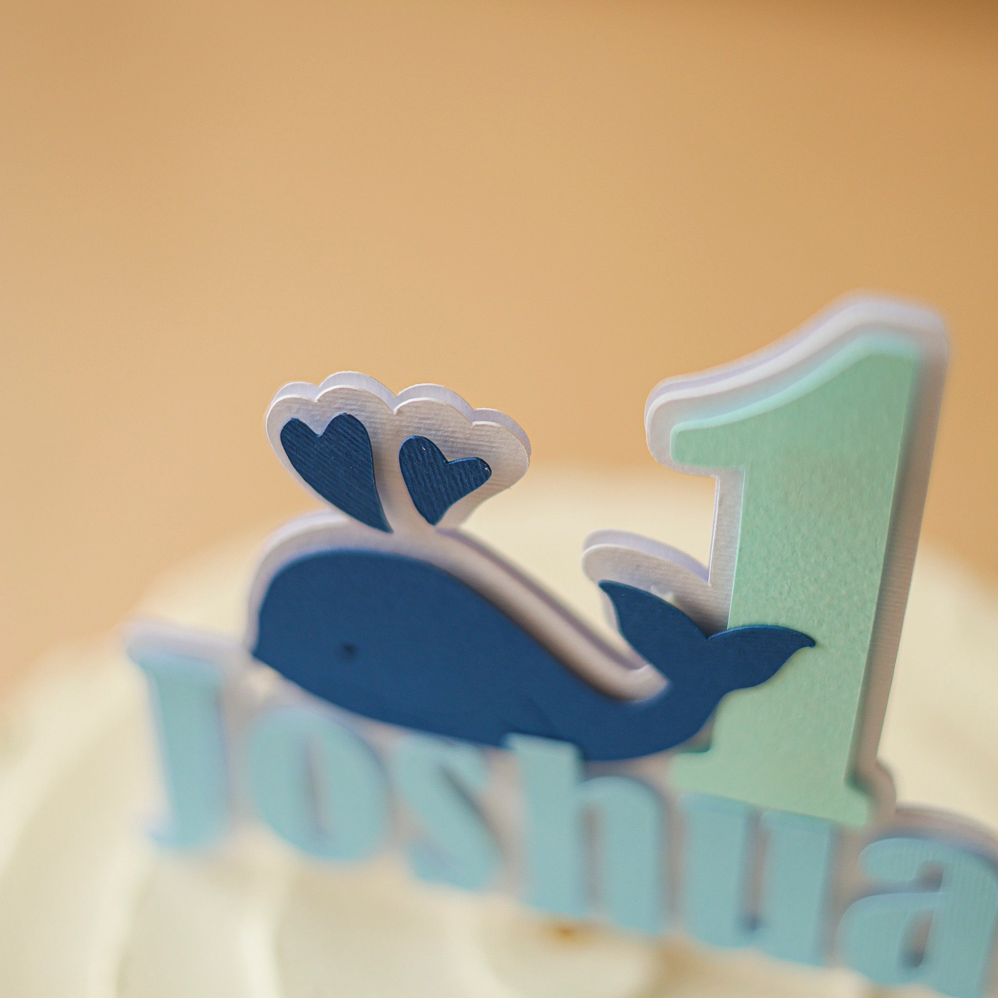 Cake topper with whale design and number '1' 