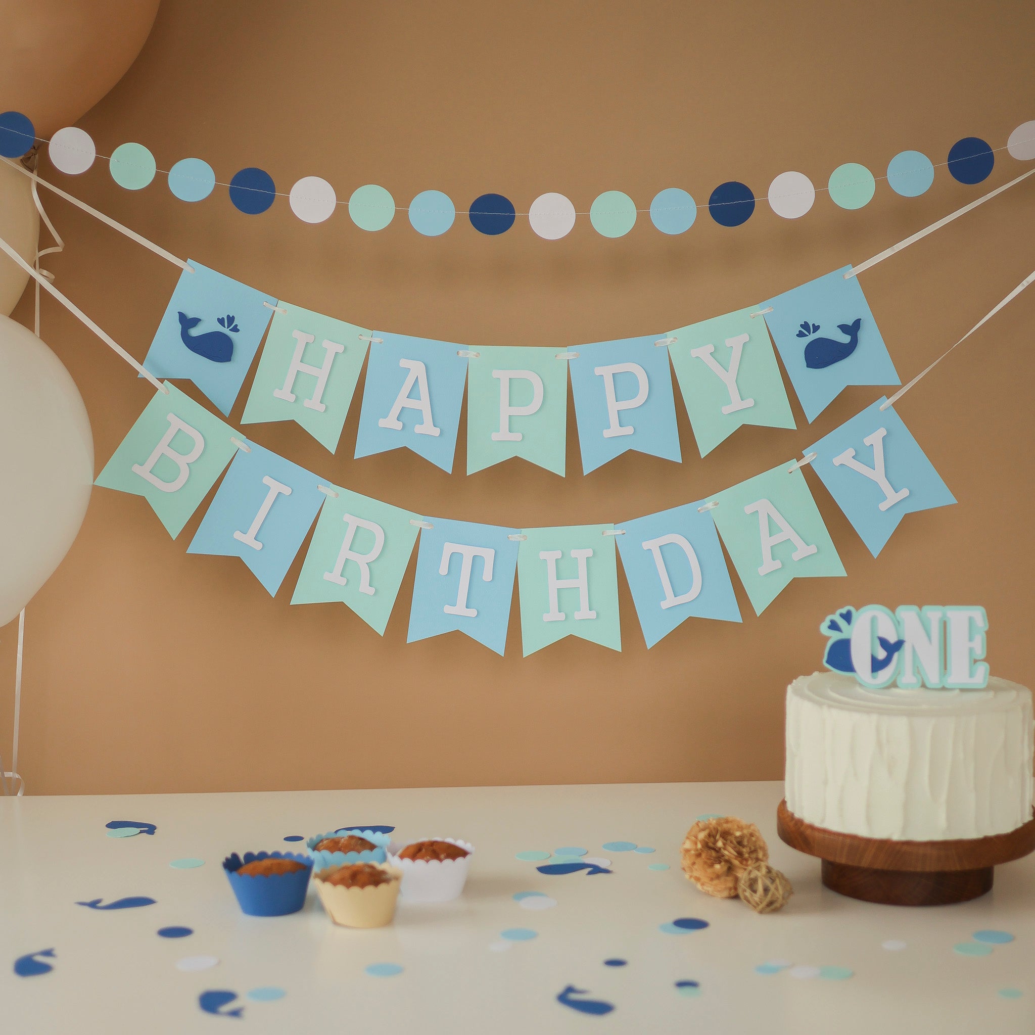 Handmade blue and mint whale birthday banner for a nautical themed first birthday party.