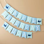 Handmade blue and mint whale birthday banner for a nautical themed first birthday party.