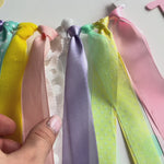 A pastel birthday banner spelling 'TWO' with a donut decoration