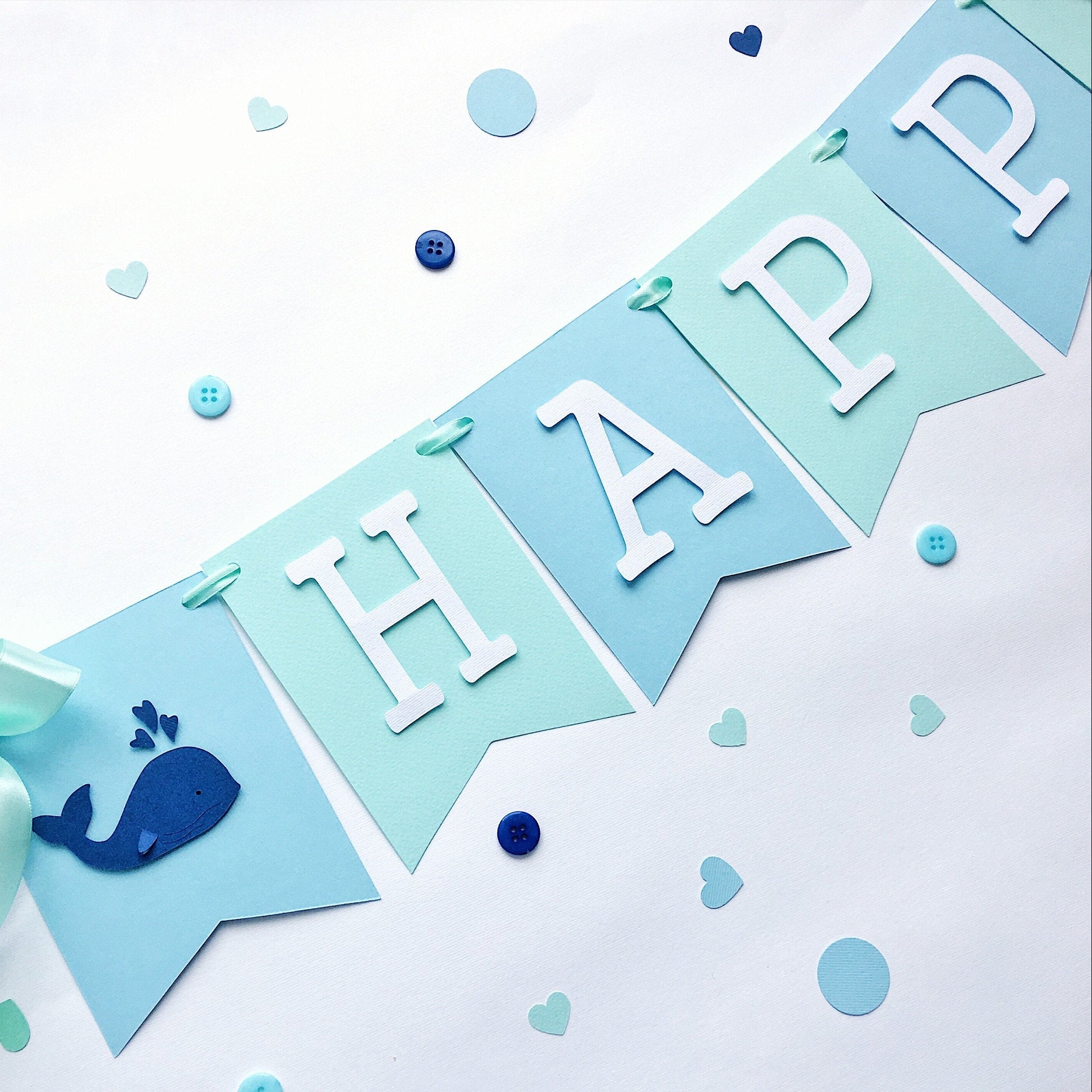 Handmade blue and mint whale birthday banner for a nautical themed first birthday party.
